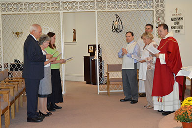 The chapter gathers in prayer during a retreat in a church.